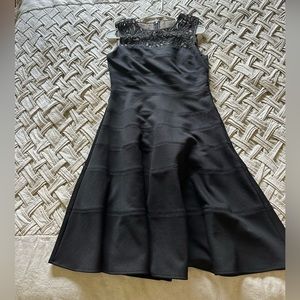 Black sleeveless cocktail dress with lace detail, size M